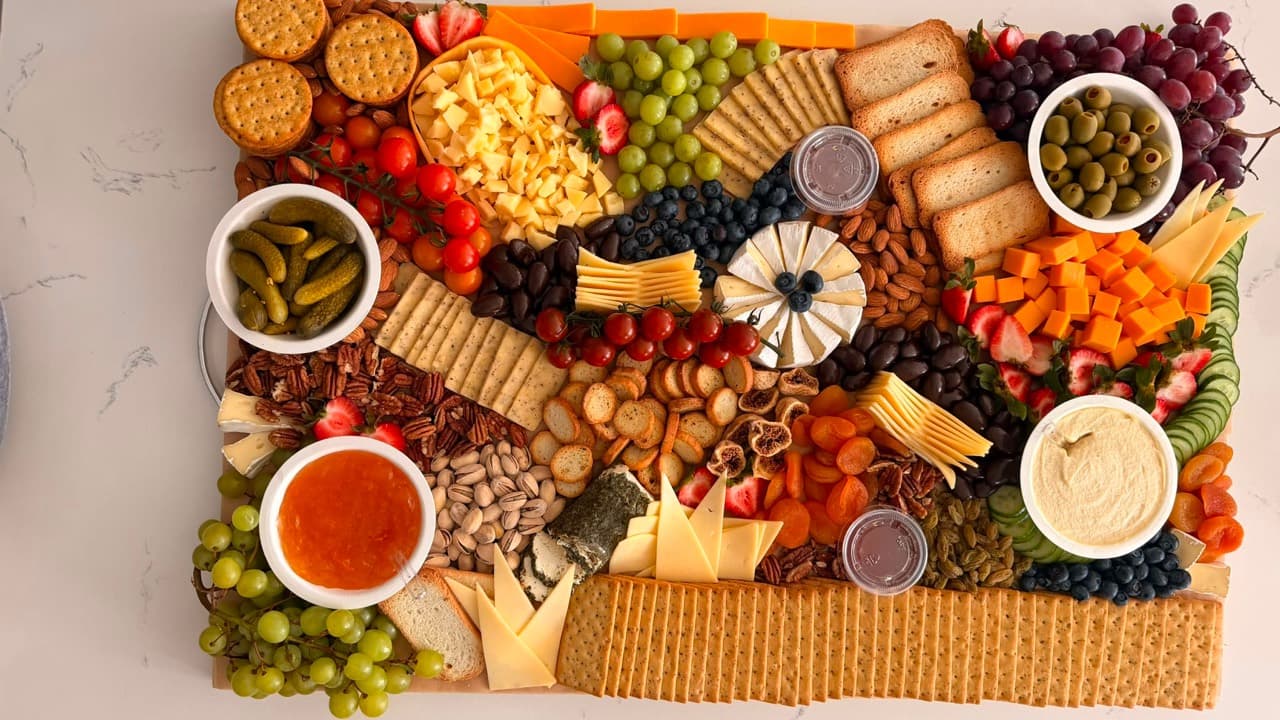 Abundant charcuterie spread styled with cheese, fruit and accompaniments